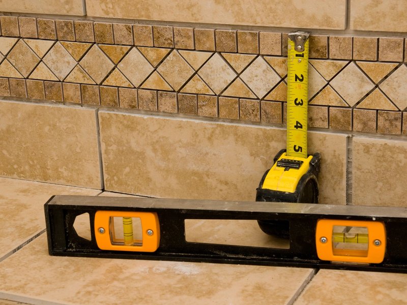 measuring tape and level on tile - Contract Interiors, IN